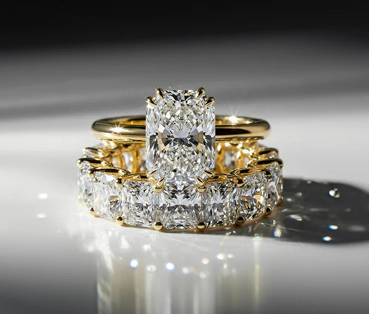 Radiant cut diamond solitaire with matching eternity band in yellow gold